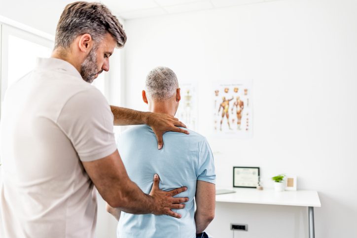 Confident successful mature doctor at hospital